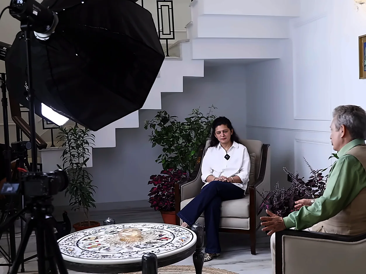 Bintin Media corporate interview shoot in Delhi with Godox softbox lights, camera on tripod and a foreign guest in conversation