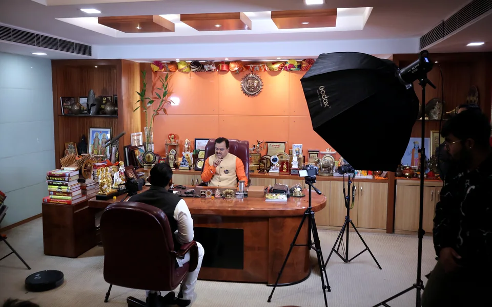 Bintin Media crew setting up a documentary interview with softbox lighting in a leader's office