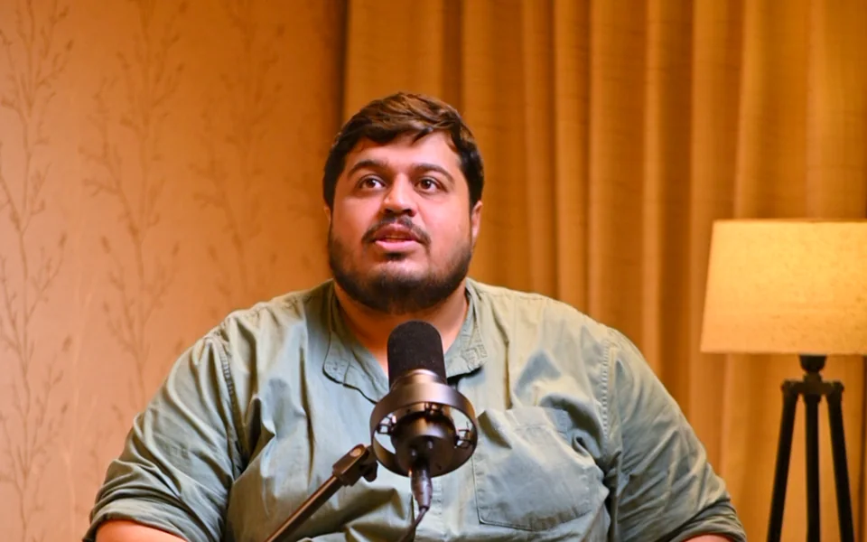 Founder recording a podcast with a studio microphone at Bintin Media