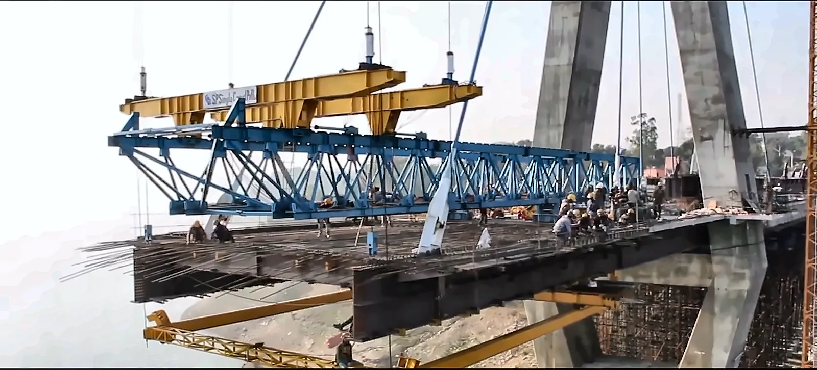 Segment launcher placing a deck section on a cable-stayed bridge, from the IRCON International corporate film by Bintin Media