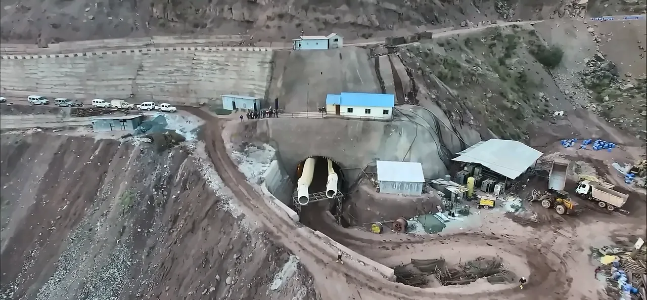 Drone shot of an IRCON railway tunnel portal under construction in the mountains, from the IRCON corporate film