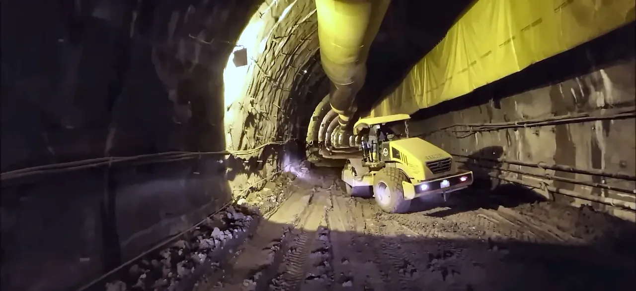 Roller compactor working inside a railway tunnel, from the IRCON International corporate film