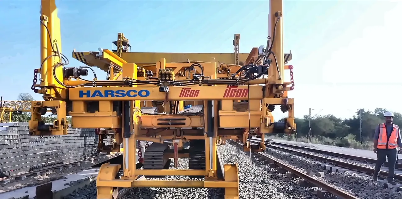 Track-laying machine on a new railway line with an IRCON engineer in safety gear, from the IRCON corporate film