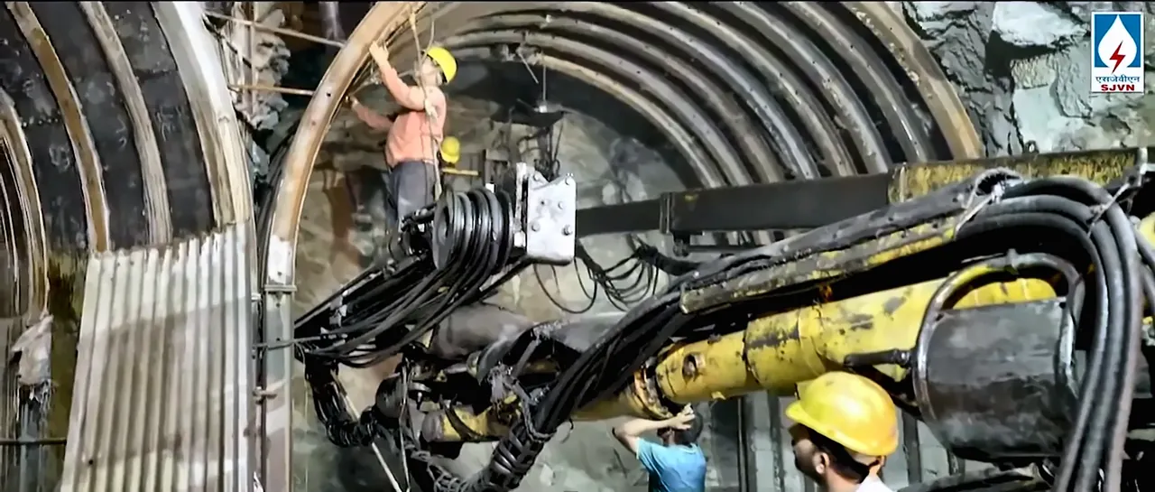 Workers and a drilling rig inside an SJVN hydro project tunnel, from the SJVN corporate film by Bintin Media