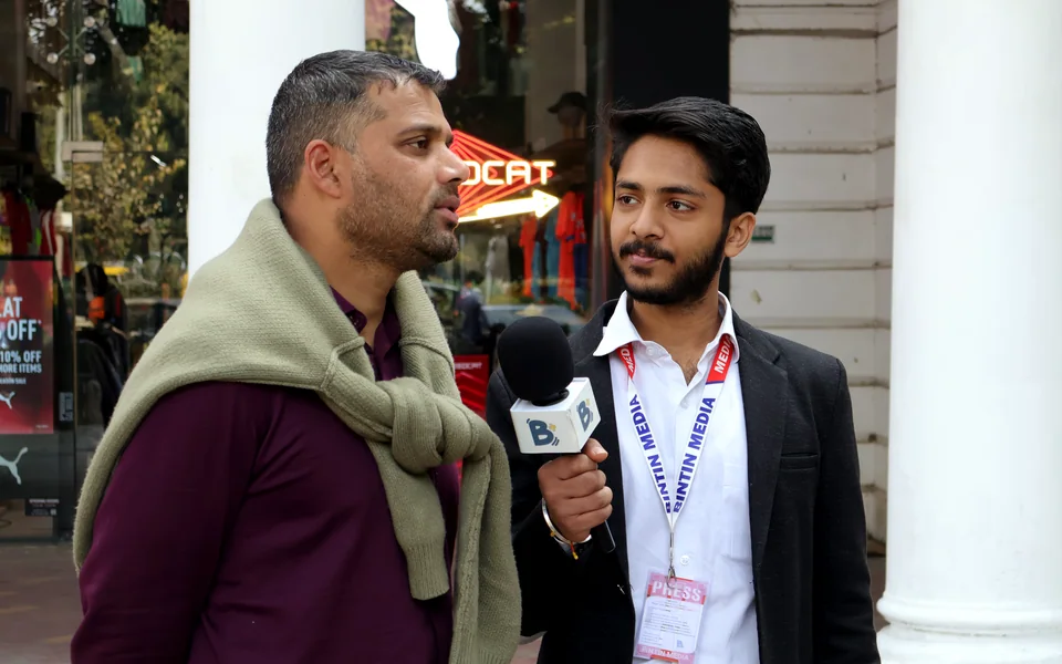 Bintin Media reporter interviewing a passer-by at Connaught Place, New Delhi, for social media content